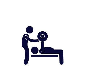 A silhouette of a personal trainer spotting his client bench pressing