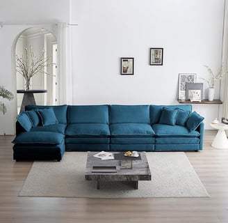 a blue couch with pillows and a coffee table