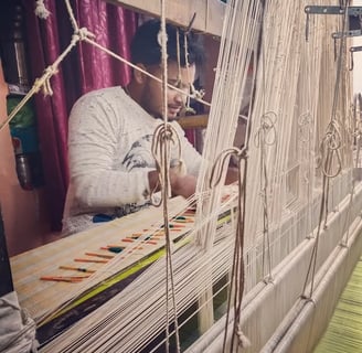 a man is working on a weaving machine