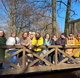 a group of happy women standing on a bridge