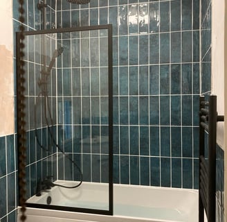 green tiles with black frame glass shower screen - installed by Rupert De La Mare