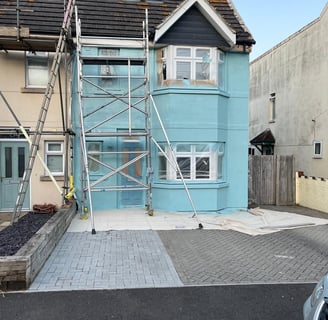 blue house after spraying by Rupert De La Mare