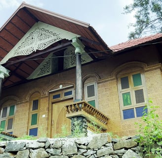 a house with a stone wall and a stone wall