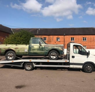 a car being delivered by a tow truck
