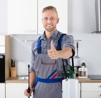 a male plumber in a kitchen with a sprayer