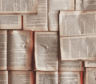 Pile of old used books open to read