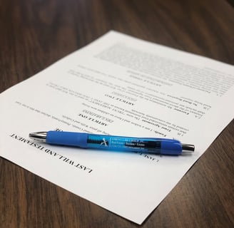 a pen with a paper on a table