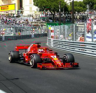 a pilot driving a Ferrari car on the Monaco F1 Grand Prix track