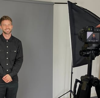 a man in a black shirt and a camera
