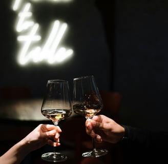 two people toasting with wine glasses