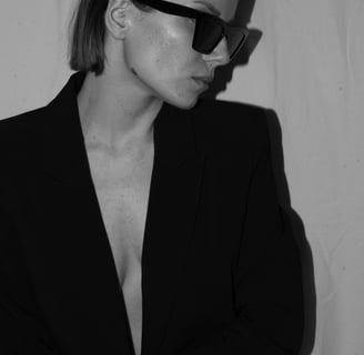 a woman in a suit and sunglasses