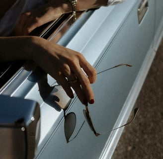 a man's hand holding a pair of glasses