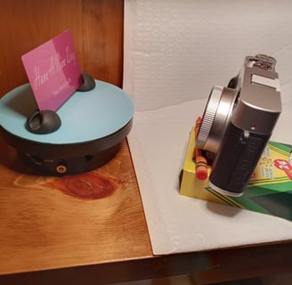 Using dollar store crayons as a tripod to take a photo of the metal card
