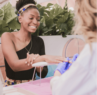 A smiling lady enjoying a manicure session