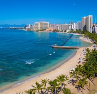 Turquoise waters meet sandy shores at Waikiki Beach,