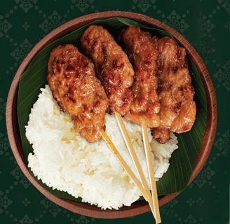 a bowl of food with chopsticks and chopsticks