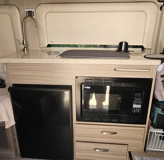 Kitchen of barely used 2023 Entegra Coach Ethos 20T Class B RV for sale.