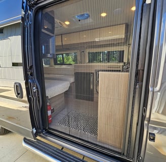 Screen door on used 2023 Entegra Coach Ethos 20T Class B RV for sale.