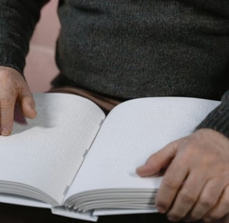 A person reading a large book, written in braille.