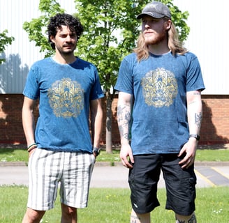 two men standing next to each other in a grassy area