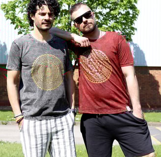 two men standing next to each other in a grassy area