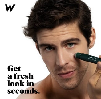 a man with a green sticker concealer