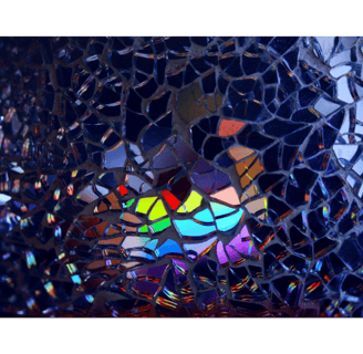 Colored lights reflecting off broken glass, symbol of examining cultural norms