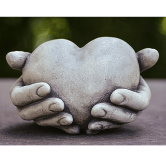 Sculpture of hands holding a heart, a symbol of healthy relationship