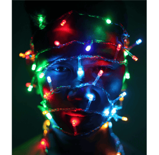 A man's head wrapped in fairy lights, a symbol of their needs and expectations in relationships