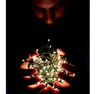 Man holding bundle of fairy lights, symbol of self-reflection