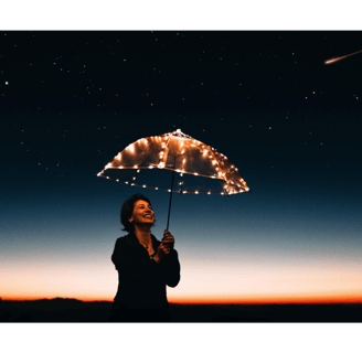 Woman holding lit up umbrella under starry sky with shooting star, she is smiling