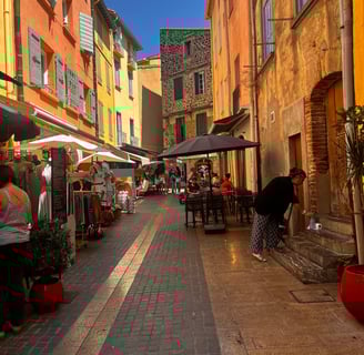 a narrow street with people walking down the street