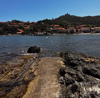a pier with a view of a beach and a boat