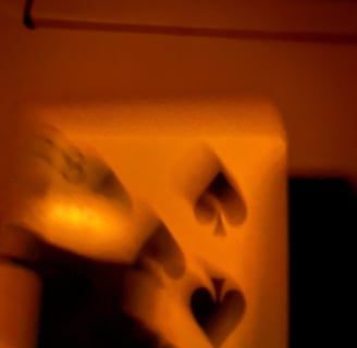 a person holding a knife and knife in front of a wall