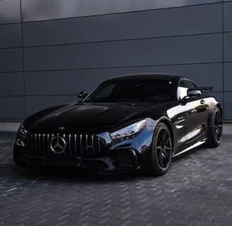 Black sports car detailed with mirror finish and full paint restoration
