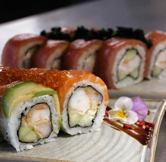 a plate of sushi rolls with a sauced and sauce