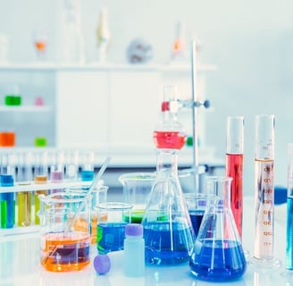 a laboratory table with a lot of different colored liquids