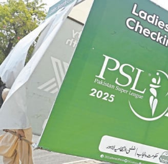 Man carrying a dismantled PSL 2025 ladies security booth on a street in Lahore.