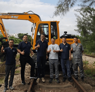 a group of men standing on a train track
