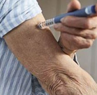 a man with a needled arm holding a pen