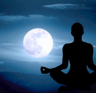 Silhouette of a person meditating under a full moon, representing mental clarity and mindfulness