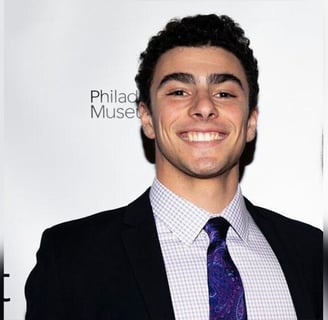 a man in a suit and tie smiling