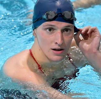 a man in a swimming cap and goggles in a swimming pool