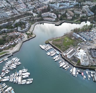 a cityscape of a harborfront with boats and buildings