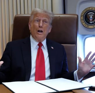 a man in a suit and tie is sitting at a desk