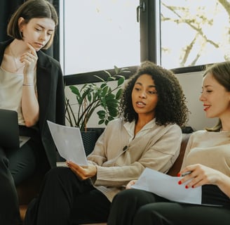 Three business women discussing branding strategy