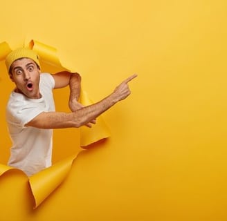 a man with a hat and a hat on his head is looking through a hole