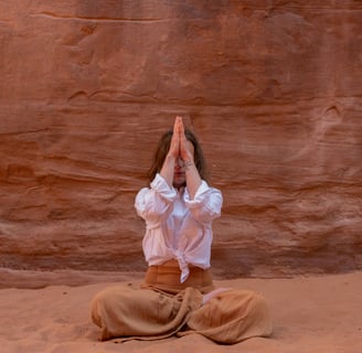 a woman in a white shirt and pants is doing yoga
