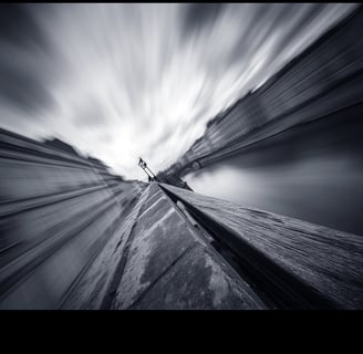 a person standing on a rock in the middle of a mountain