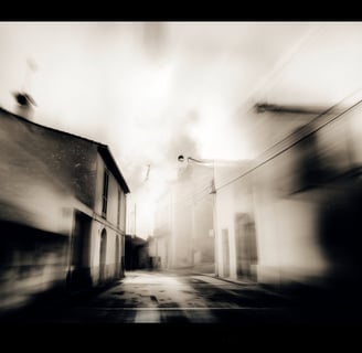 a street scene with a blurry image of a street light